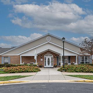 A suburban-style residential building with a well-maintained entrance and landscaping.