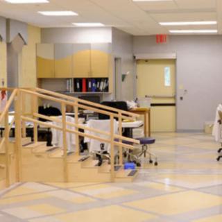A physical therapy room equipped with rehabilitation tools and exercise equipment.