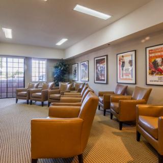 A comfortable lobby featuring leather chairs and decorative artwork on the walls.