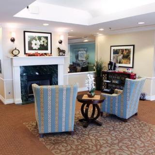 A cozy lobby area with comfortable seating and a stylish fireplace.