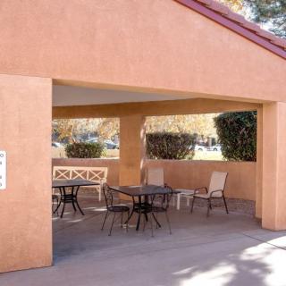 A covered patio area with tables and chairs providing outdoor seating.