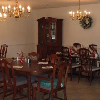An elegant dining room with wooden furniture and chandeliers.