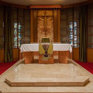 A beautifully designed church altar with intricate woodwork and religious symbols.