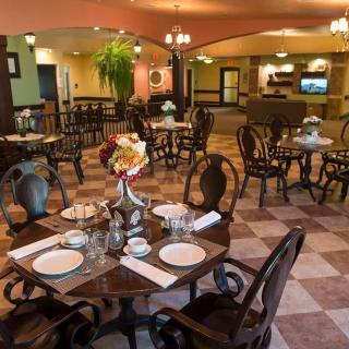 An elegantly furnished restaurant interior with neatly arranged tables and chairs, ready for guests.