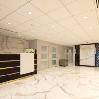 A modern, elegant lobby with a marble floor and reception area.