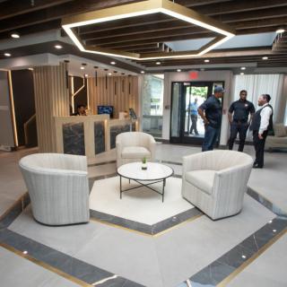 A modern lobby with a stylish seating area and unique lighting fixtures.