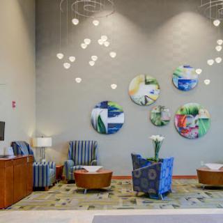 A modern lobby featuring stylish seating, artistic wall decor, and contemporary lighting.