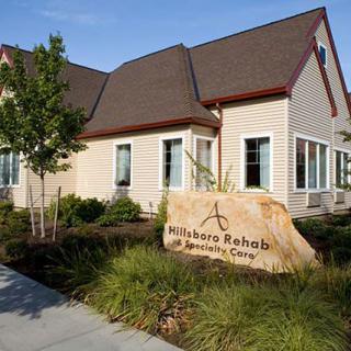 A rehabilitation center with a prominent sign and well-maintained landscaping.