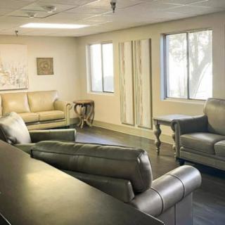 A comfortable lounge area with sofas and natural lighting.
