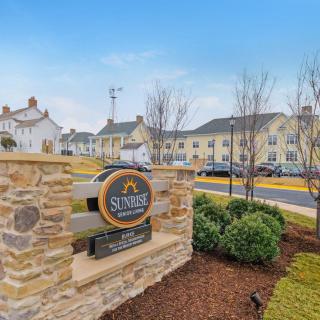 A suburban neighborhood with neatly landscaped surroundings and a welcoming entrance sign.