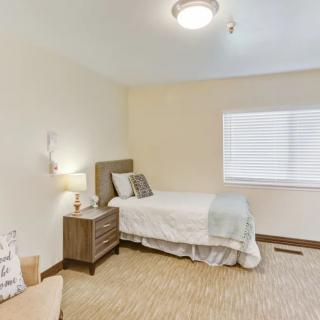 A minimalist bedroom with a single bed and nightstand.