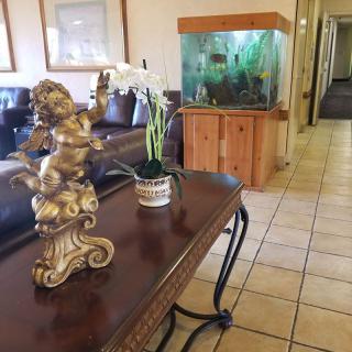 A lobby area featuring a decorative statue and an aquarium.