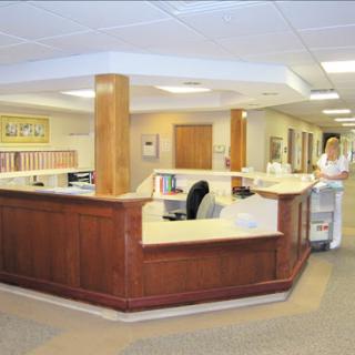 A spacious reception area in a healthcare facility, featuring wooden accents and a welcoming atmosphere.