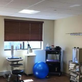 A physical therapy room equipped with exercise and medical tools.