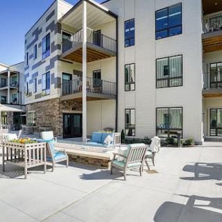 A modern residential complex featuring outdoor lounge areas and balconies, perfect for relaxation and socializing.