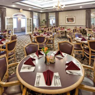 A well-arranged dining area with neatly set tables and chairs.