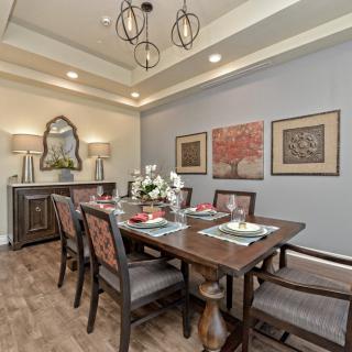 A modern dining room with a beautifully set table and elegant decor.