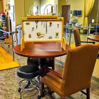 A physical therapy room featuring a table with various rehabilitation tools and equipment.