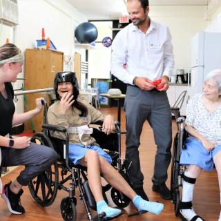 Caregivers engaging with elderly residents in a nursing home.