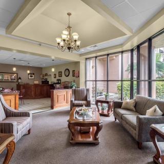 A well-furnished lobby with comfortable seating and large windows.
