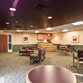 A hotel lobby with seating and a reception desk.