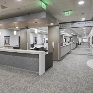 A modern office reception area with a spacious hallway and bright lighting.