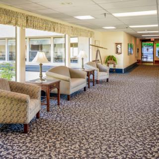 A spacious lobby with comfortable seating and a patterned carpet.