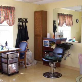Interior view of a hair salon with styling stations and chairs.