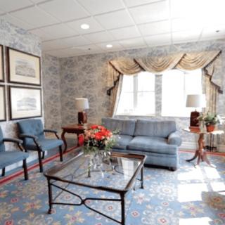 A cozy living room with elegant furniture and floral decor.