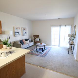 A cozy and modern living room with ample natural light and stylish furnishings.