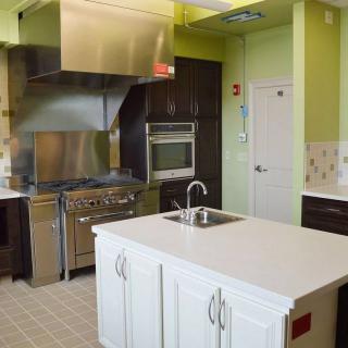 A modern kitchen with stainless steel appliances and a central island.