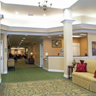 A spacious lobby area with a seating arrangement and decorative lighting.
