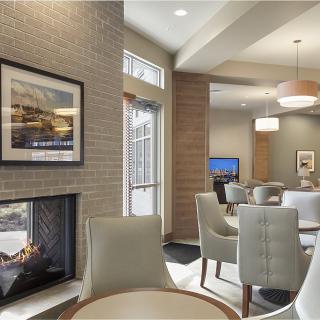 A modern lobby area featuring comfortable seating, a fireplace, and contemporary decor.