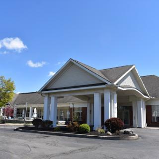 A welcoming hospitality building set against a clear blue sky.
