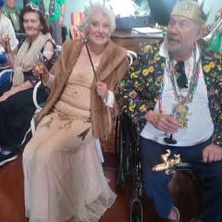 A joyful moment at a festive gathering, featuring elegantly dressed guests enjoying the celebration.
