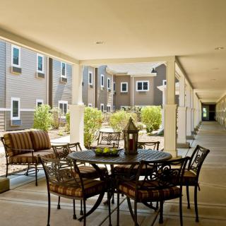 A cozy outdoor seating area in an apartment complex courtyard.