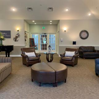 A modern and spacious living room with comfortable seating and elegant decor.