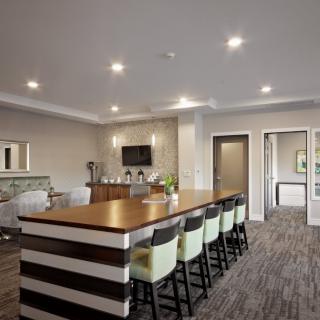 Modern kitchen interior with a large island and seating area.