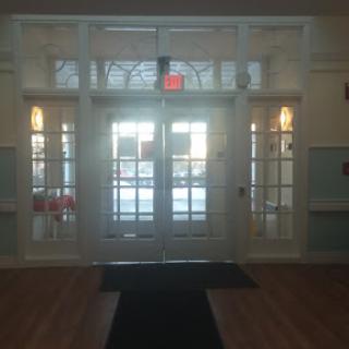 An inviting entrance with glass doors and a spacious lobby.