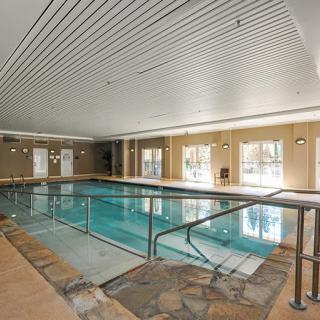 A luxurious indoor swimming pool with modern design and relaxing ambiance.