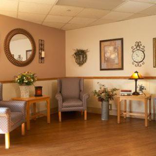 A cozy waiting room with chairs, decorative elements, and soft lighting.
