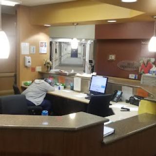 A view of the hospital reception area with staff members attending to duties.