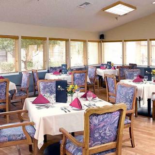A cozy dining area with neatly arranged tables and chairs.