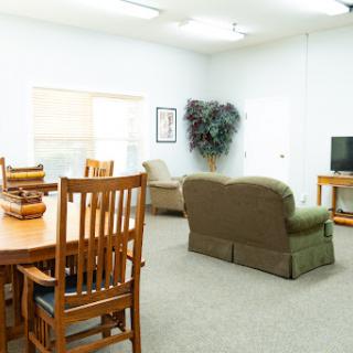 A spacious and modern living room featuring comfortable seating and a dining area.