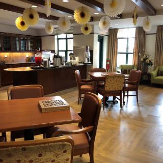 A cozy dining area with wooden tables, chairs, and charming decorations.