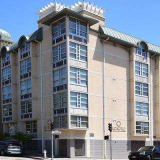 A modern residential apartment building in an urban setting.