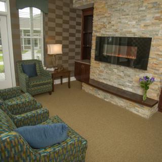 A cozy living room with a modern fireplace and comfortable seating.