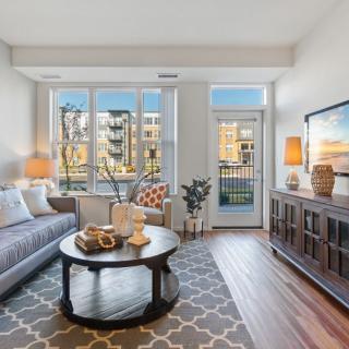 A modern living room with contemporary furniture and large windows allowing natural light.