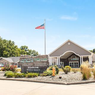 A welcoming entrance featuring a flag and landscaped surroundings.
