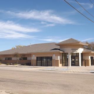 A modern commercial building set against a clear blue sky.